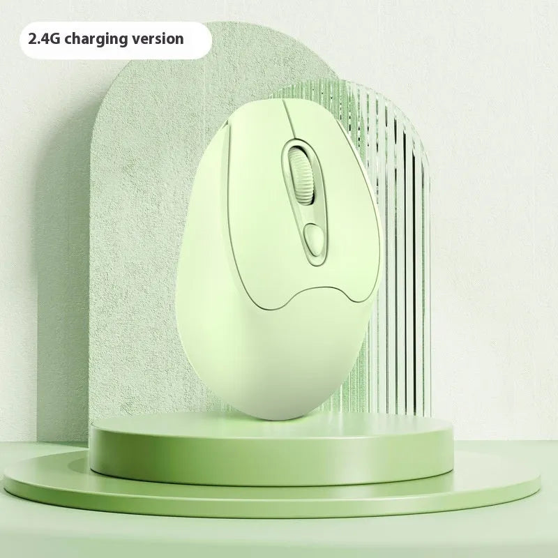 Bluetooth wireless mouse in choice of girl pink, milk tea pink, grey or green colours on a desk next to a laptop.