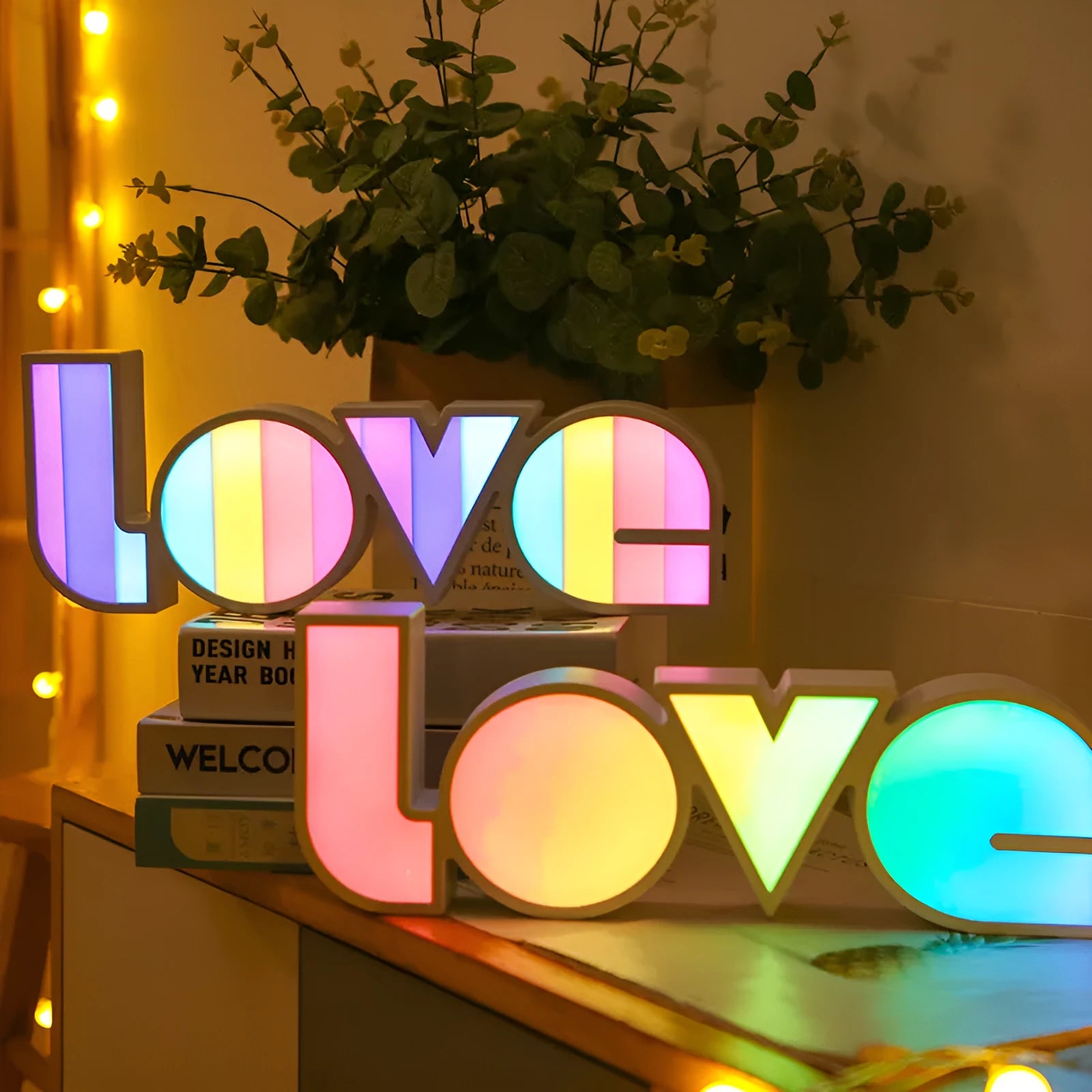 Rainbow style LED LOVE decorative table lamp with plastic shade on a table