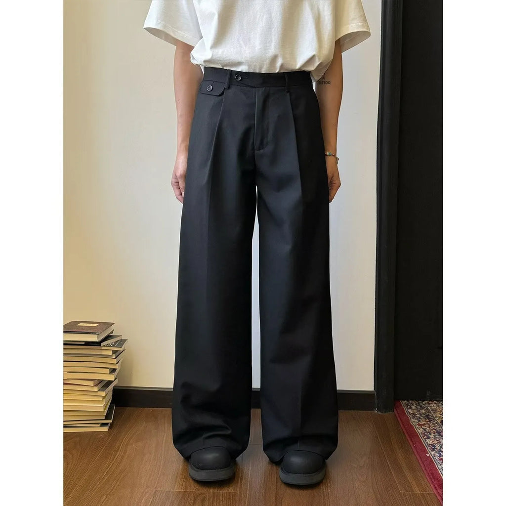 Men's straight-leg wide trousers in brown and black, showing loose fit and casual style.