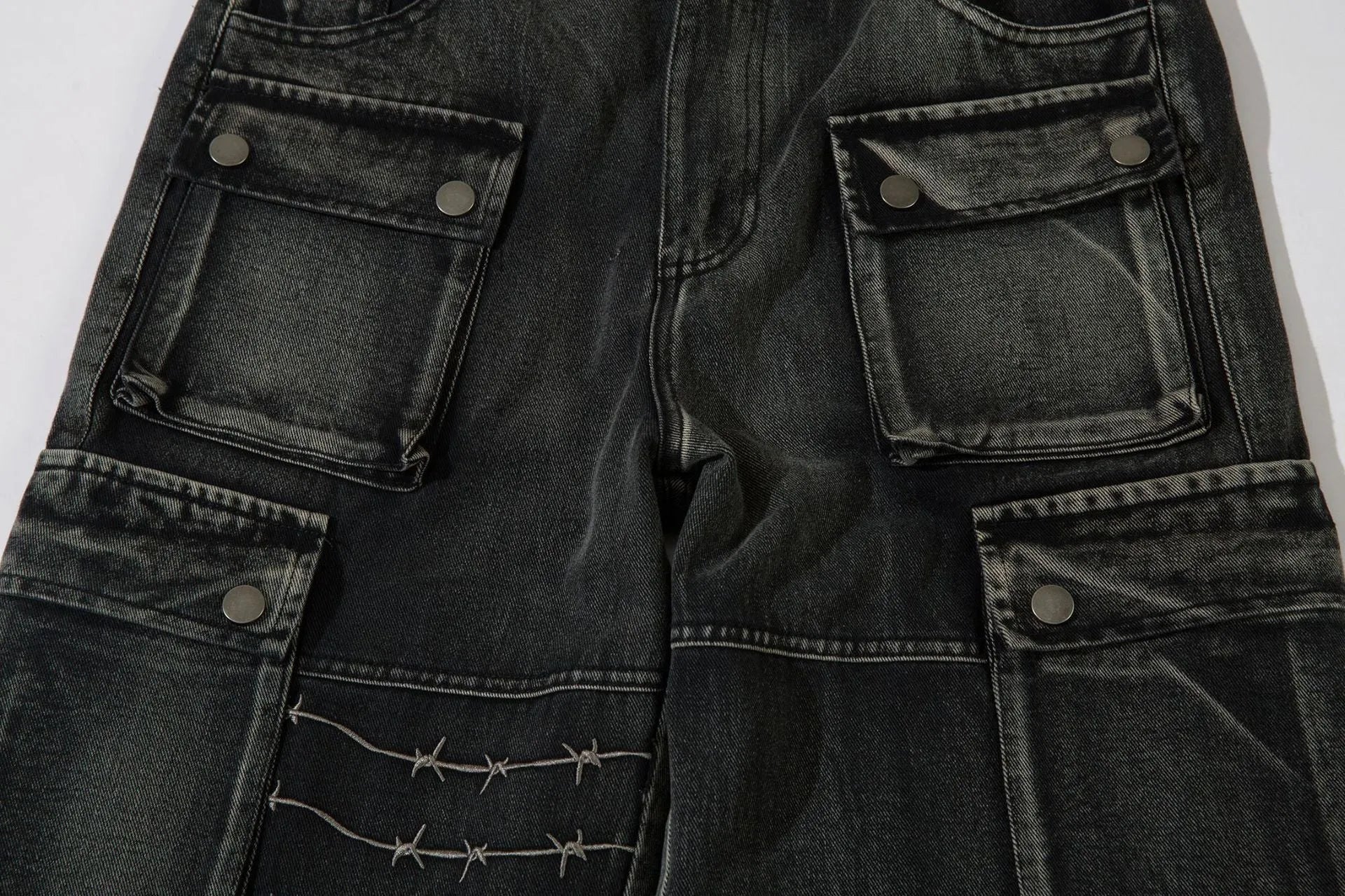 Black men's cotton wide-leg loose-fit trousers with embroidery on a mannequin.