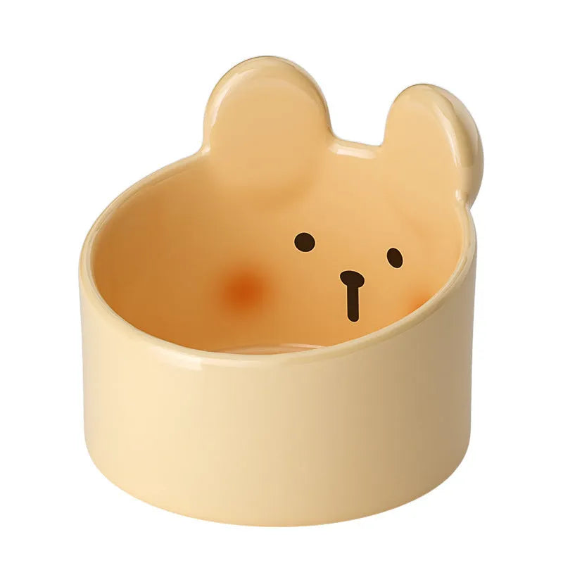 White and yellow ceramic pet bowls with raised neck guards in two sizes.