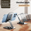 Rotatable folding mobile desktop stand in black on desk holding smartphone