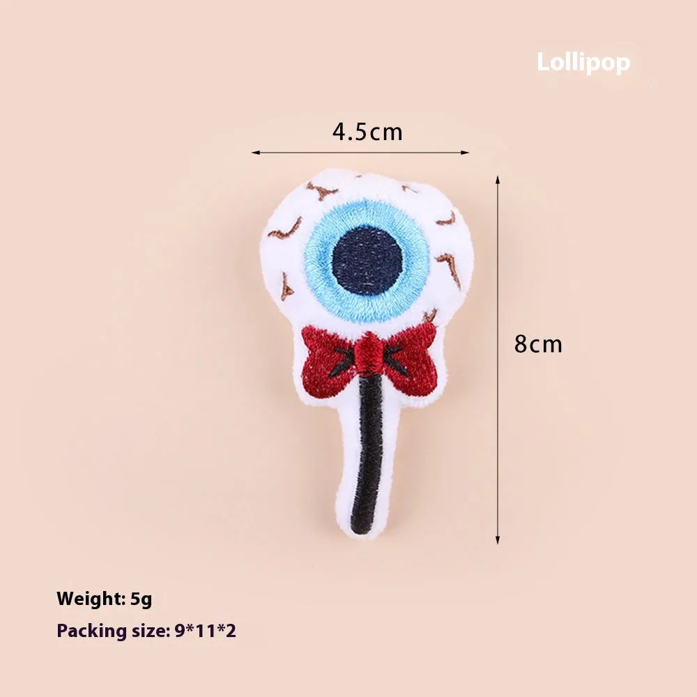 Small handheld cat teaser with plush candy and eyes attachments on wand