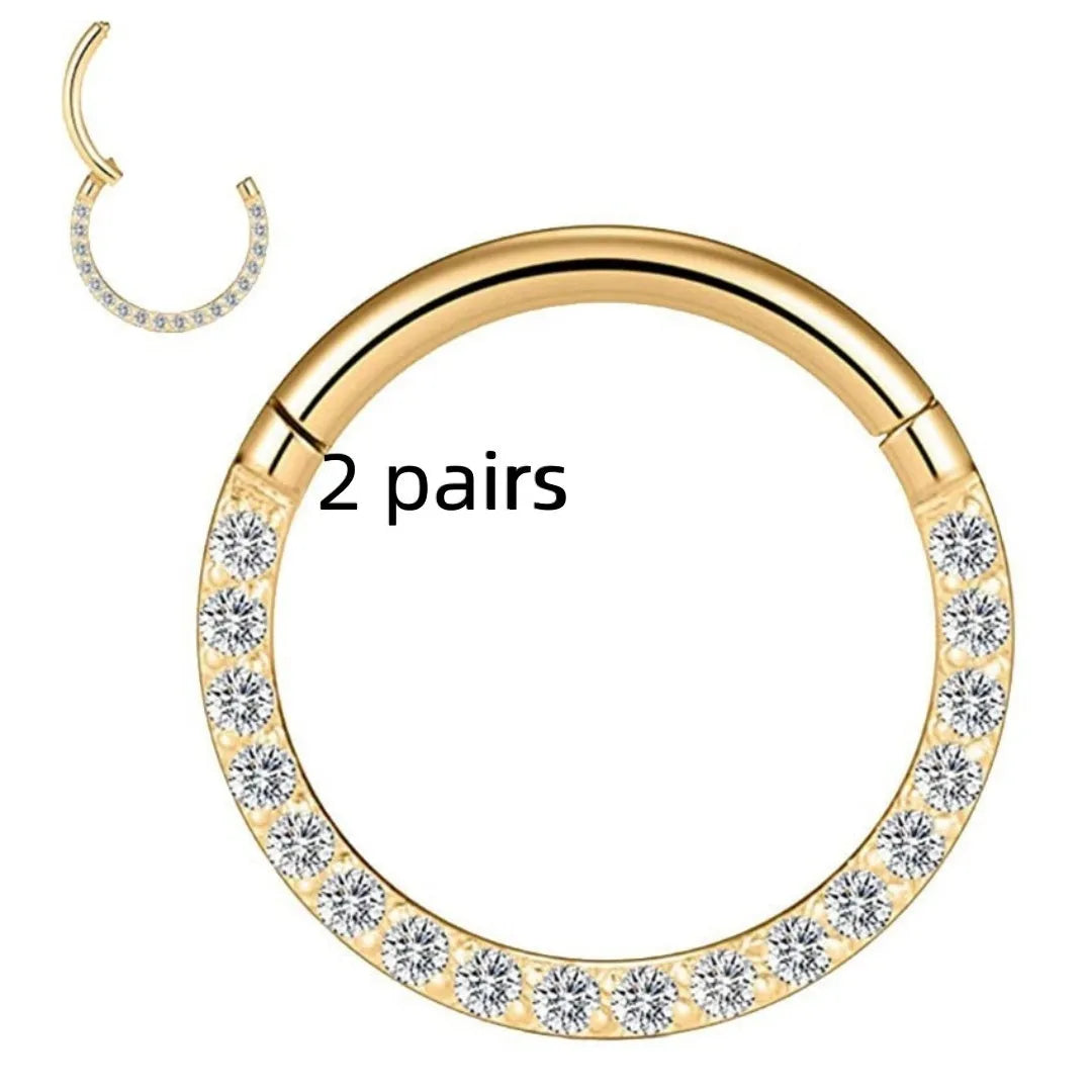 Close-up of a round, seamless stainless steel nose ring in a gold finish, showing its smooth, clasp-free design.