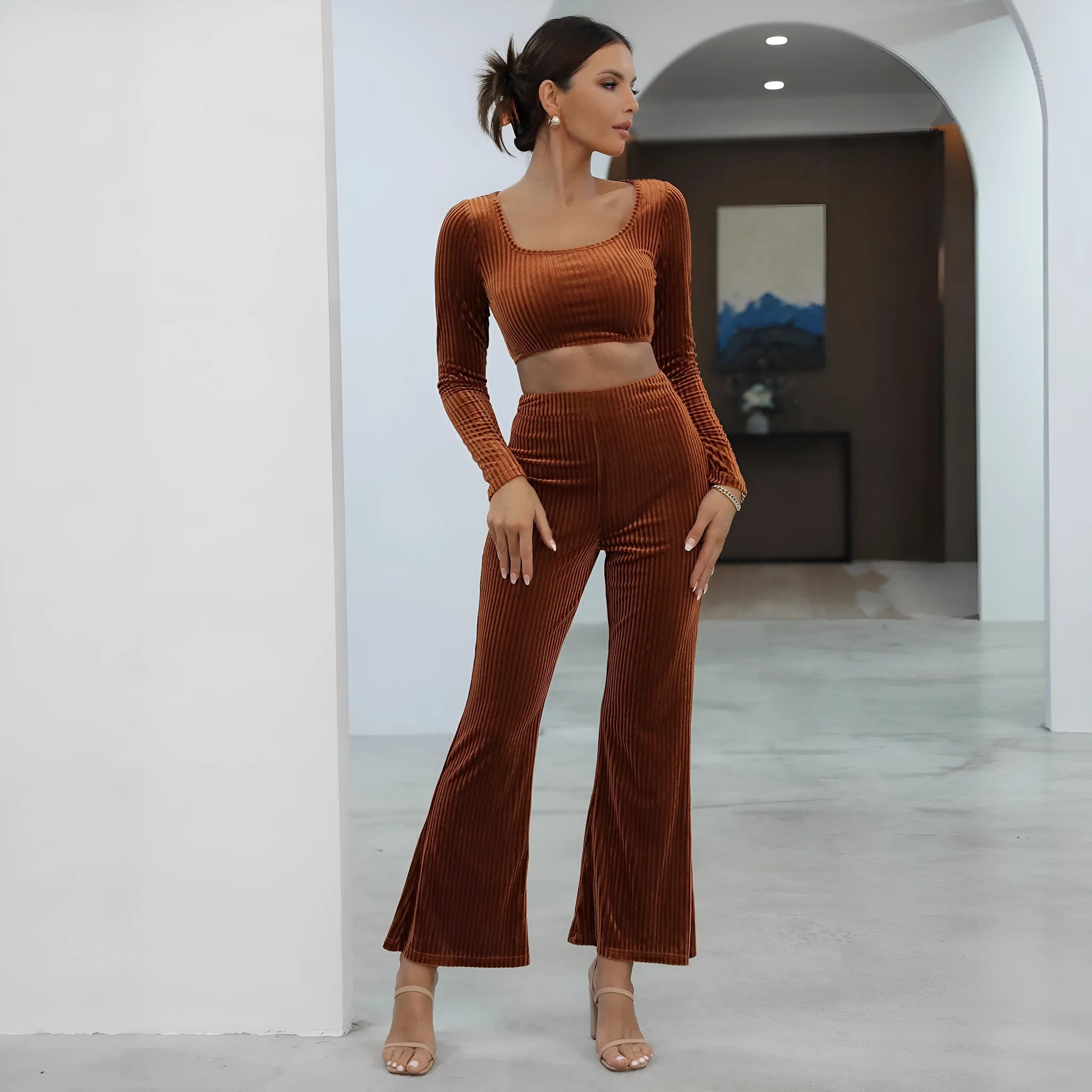 Women's caramel coloured sweater set with long sleeves and matching trousers on hanger