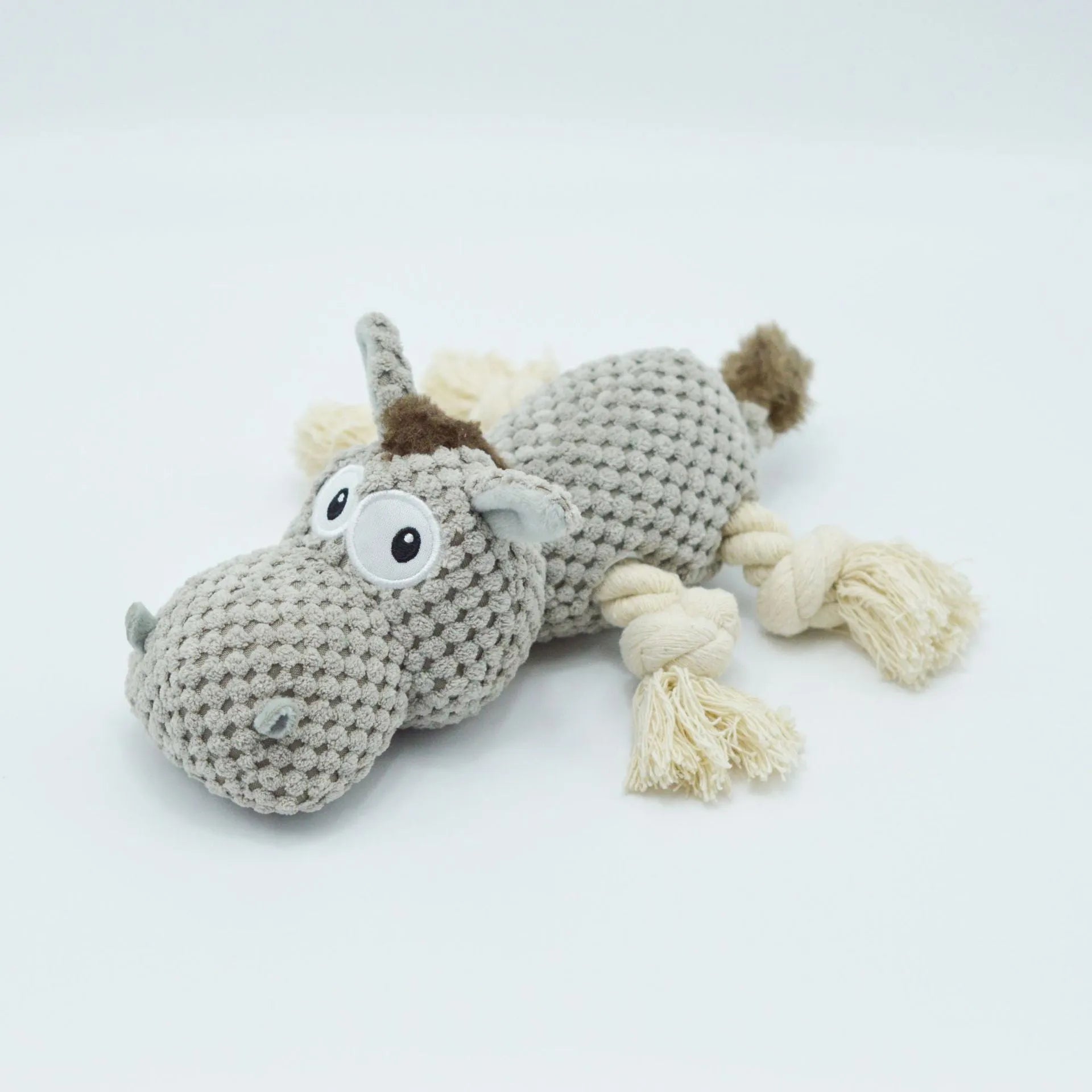 Grey plush donkey dog toy with creaking sound, showing size against a hand.