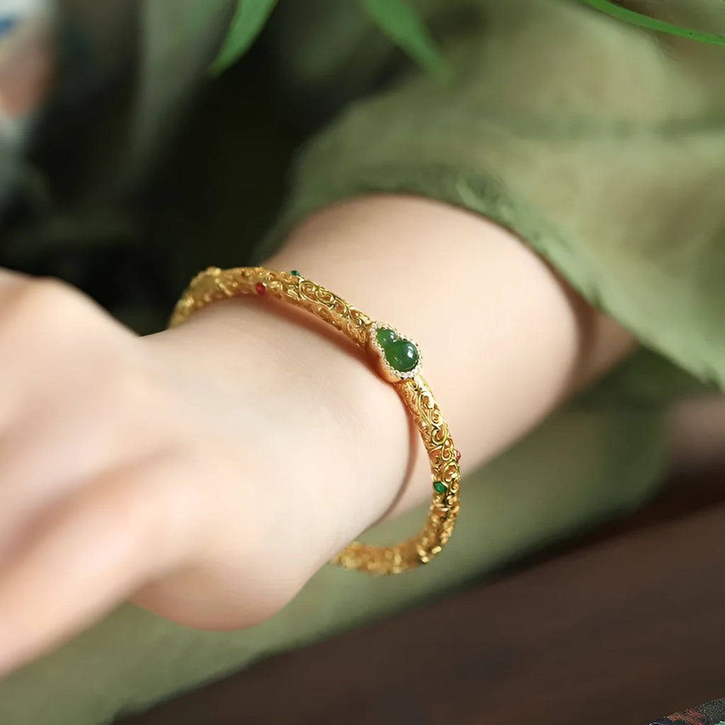 Women's gold-plated silk bracelet with adjustable knot and traditional Chinese xiangyun gourd charm