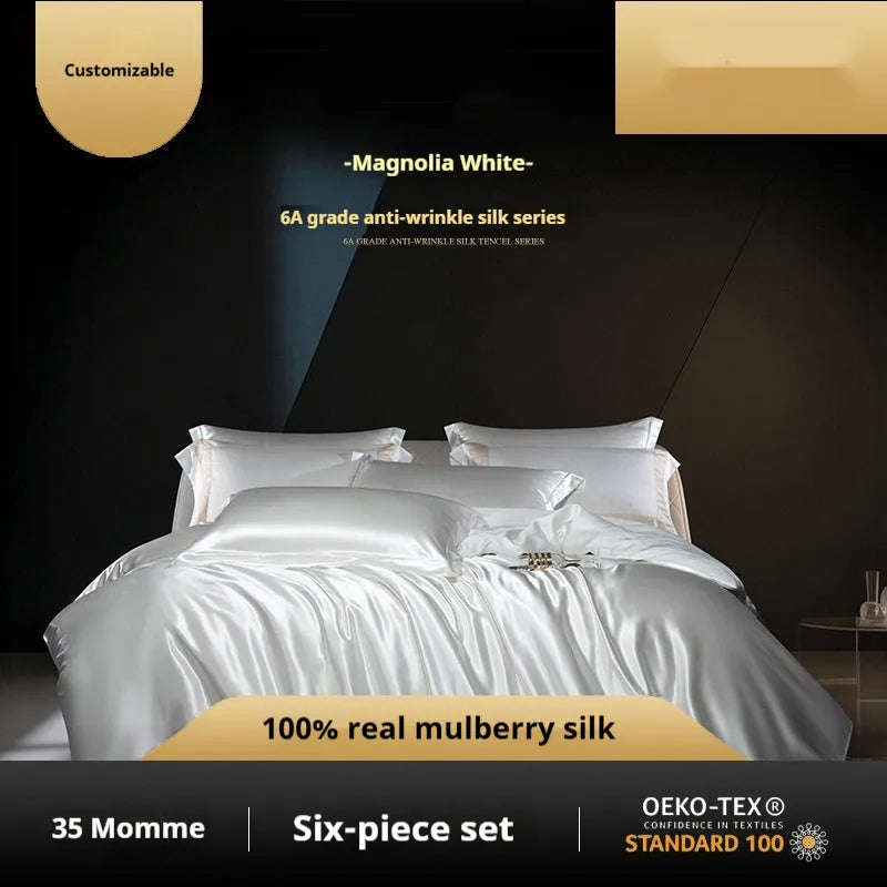 A silk four-piece quilt cover set in a solid colour, shown on a bed with matching sheets.