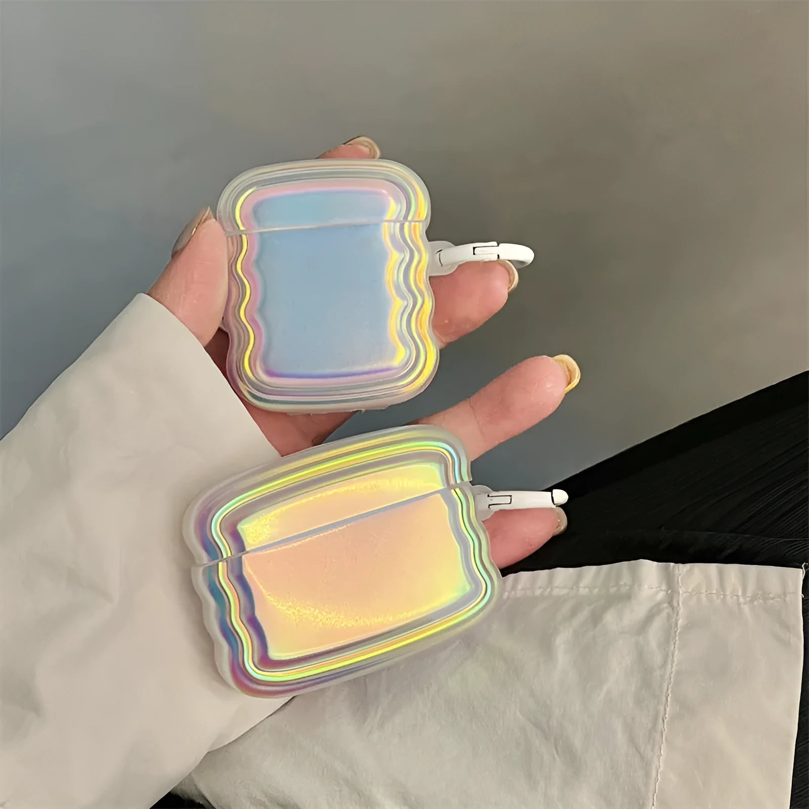 Silicone case with laser engraving and a coloured ring for Apple AirPods charging case.