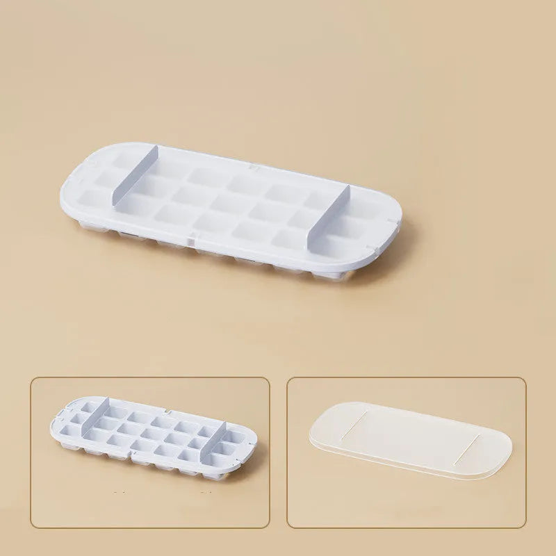Yellow lever-action ice cube tray with high-capacity grid and attached ice shovel on a blue background.
