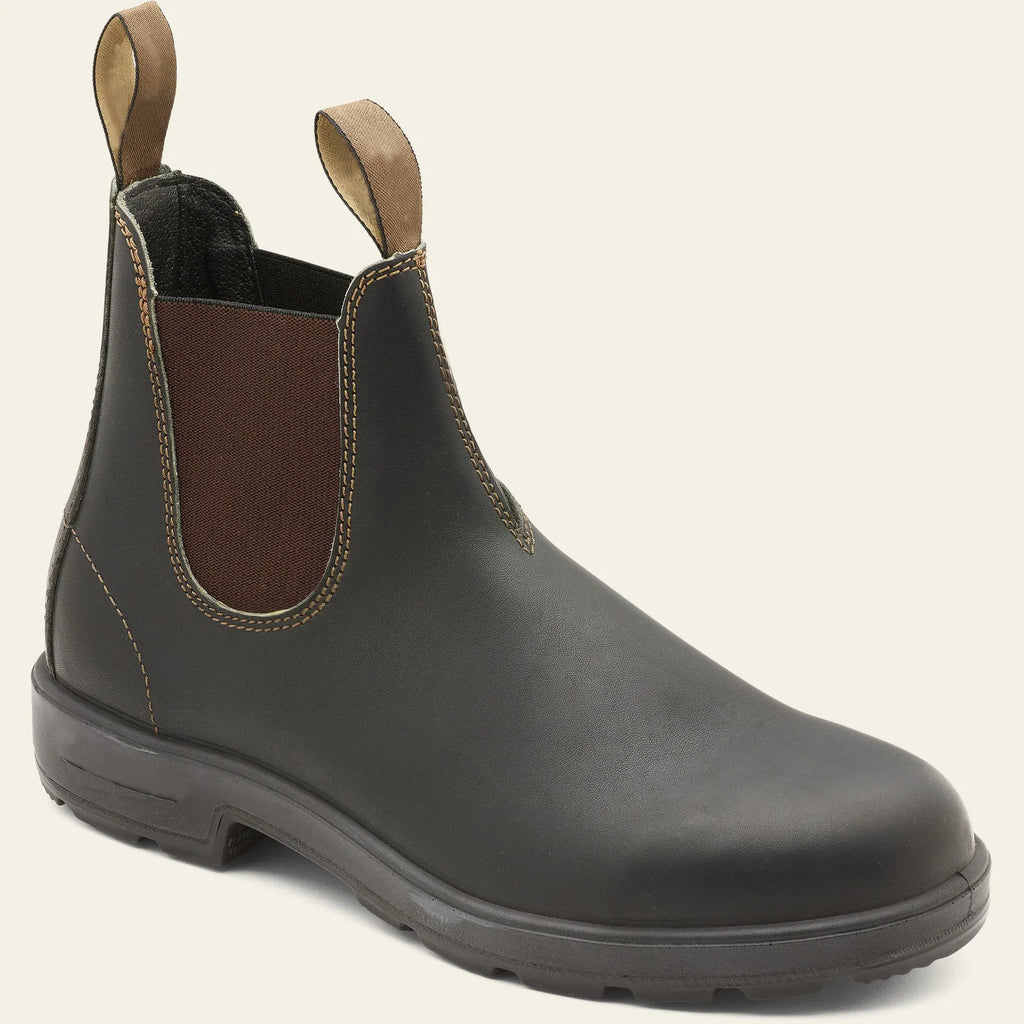 Vintage frosted brown leather Chelsea boots with round toe and car suture detailing on a wooden floor.