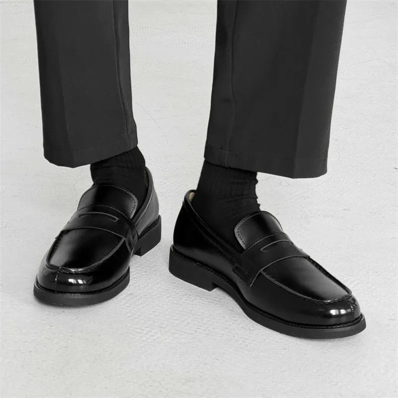 Black men's classic slip-on derby leather shoes with a rubber sole, shown in a mature style.