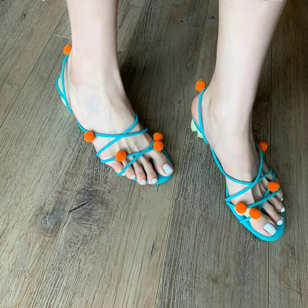 Cyan women's high-heeled sandals with lace-up ball detail and thin straps, open toe, on a rubber sole.