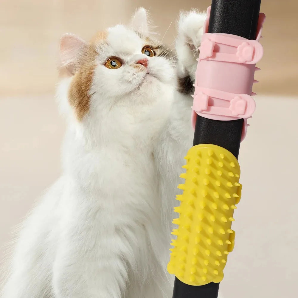 Black silicone cat grooming brush with comb teeth and an adjustable mounting strap.