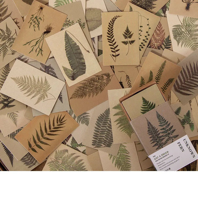 Pack of 100 small double-sided retro paper notes in various vintage colours on a wooden surface.