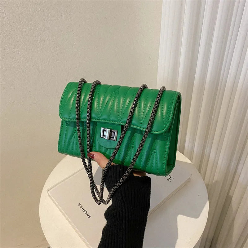 Retro textured diamond pattern women's small handbag in a choice of colours showing front view and internal phone pocket.