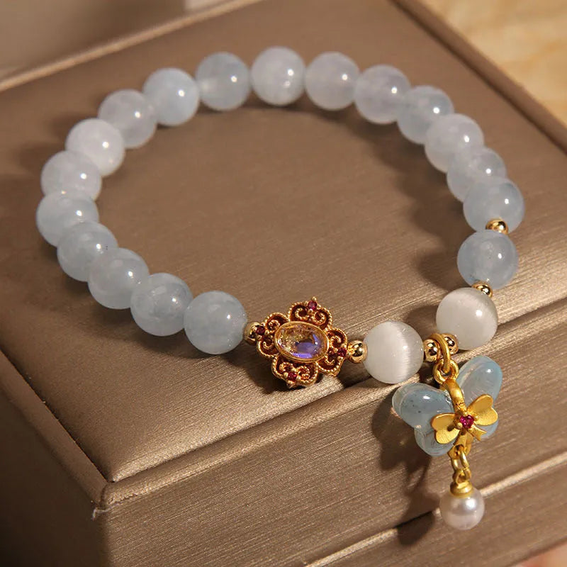 Women's crystal bracelet with aquamarine butterfly pendant and rhinestone decoration