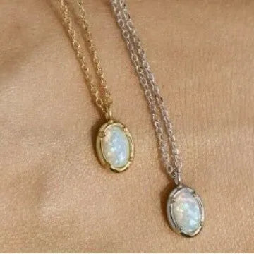 Simple geometric oval pendant necklace in gold plating on a silver chain.