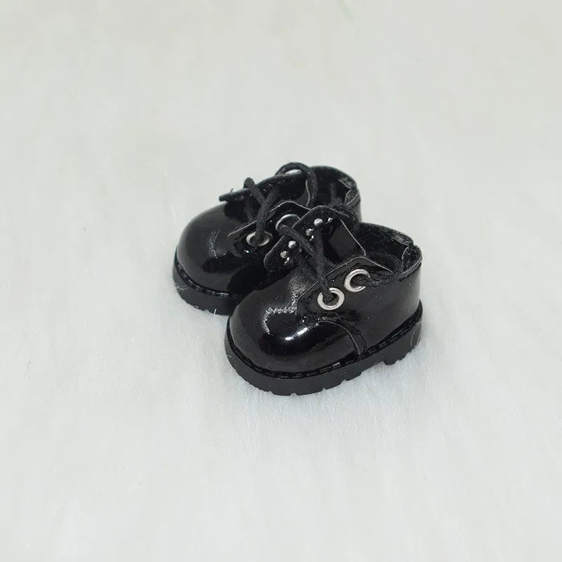 A pair of 17cm scale PU doll shoes in a selected colour and style, such as black leather shoes or brown boots.
