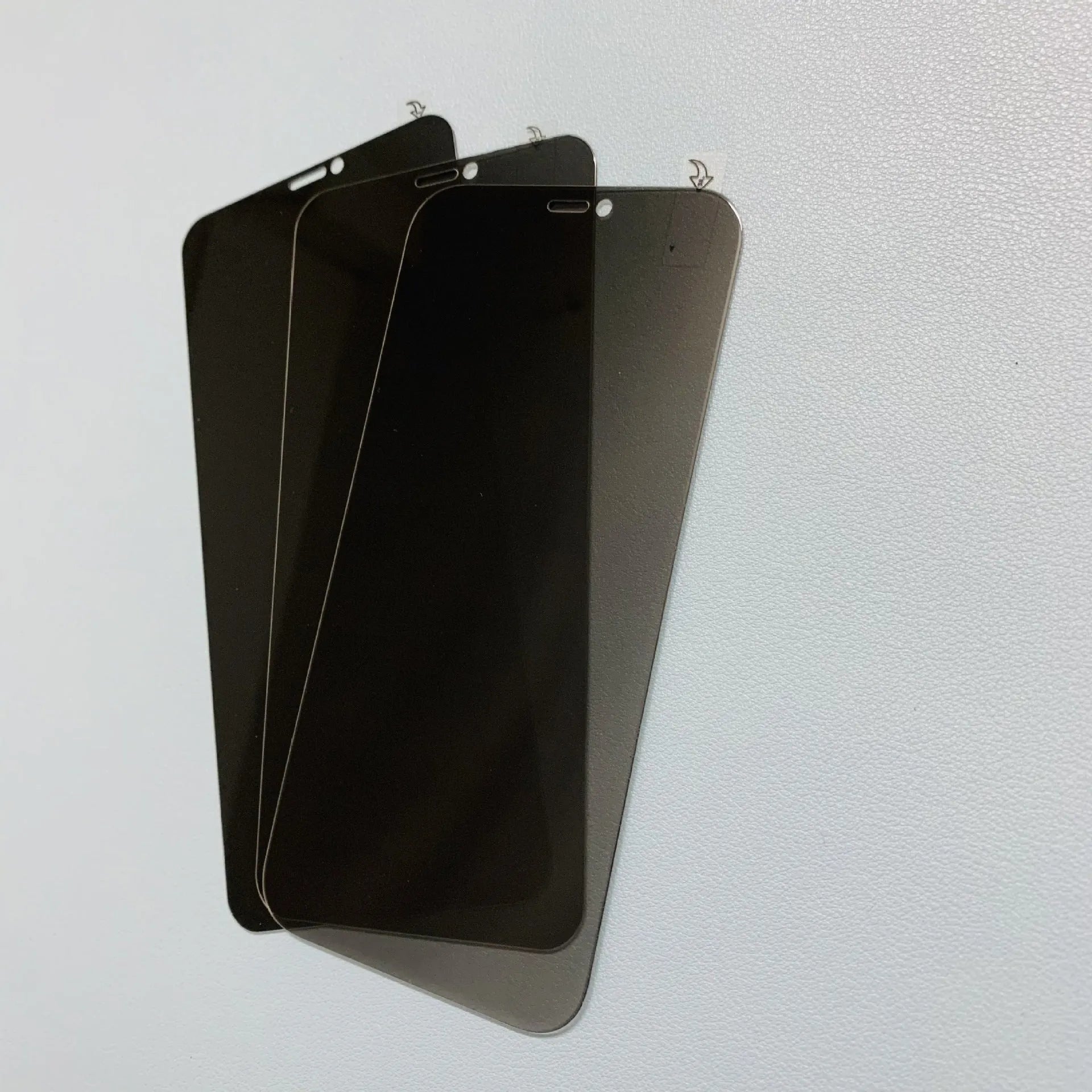 iPhone anti-peeping tempered glass screen protector showing privacy filter effect from side angle.