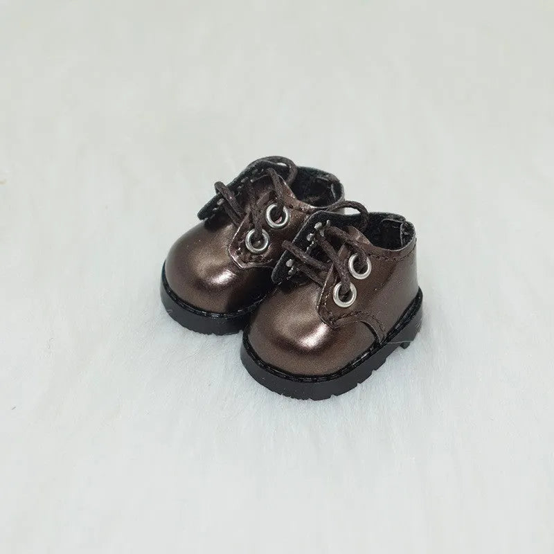 A pair of 17cm scale PU doll shoes in a selected colour and style, such as black leather shoes or brown boots.