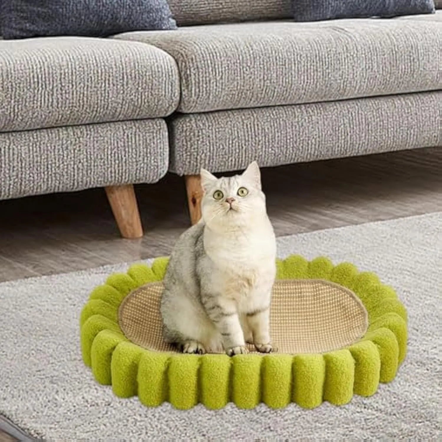Green oval cat scratcher bed made of sisal, showing scratching surface and lounging area.