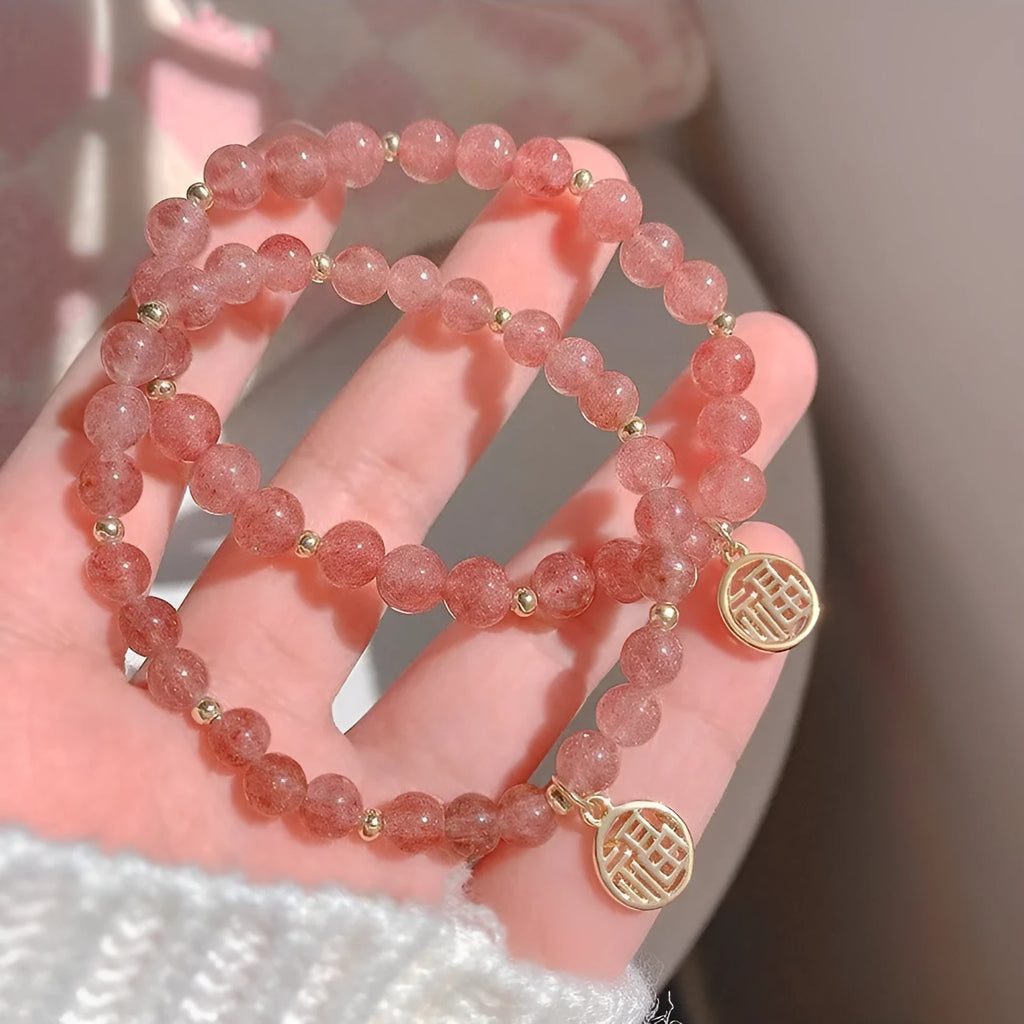 A New Chinese style glass bracelet with strawberry quartz stones and a blessing card.