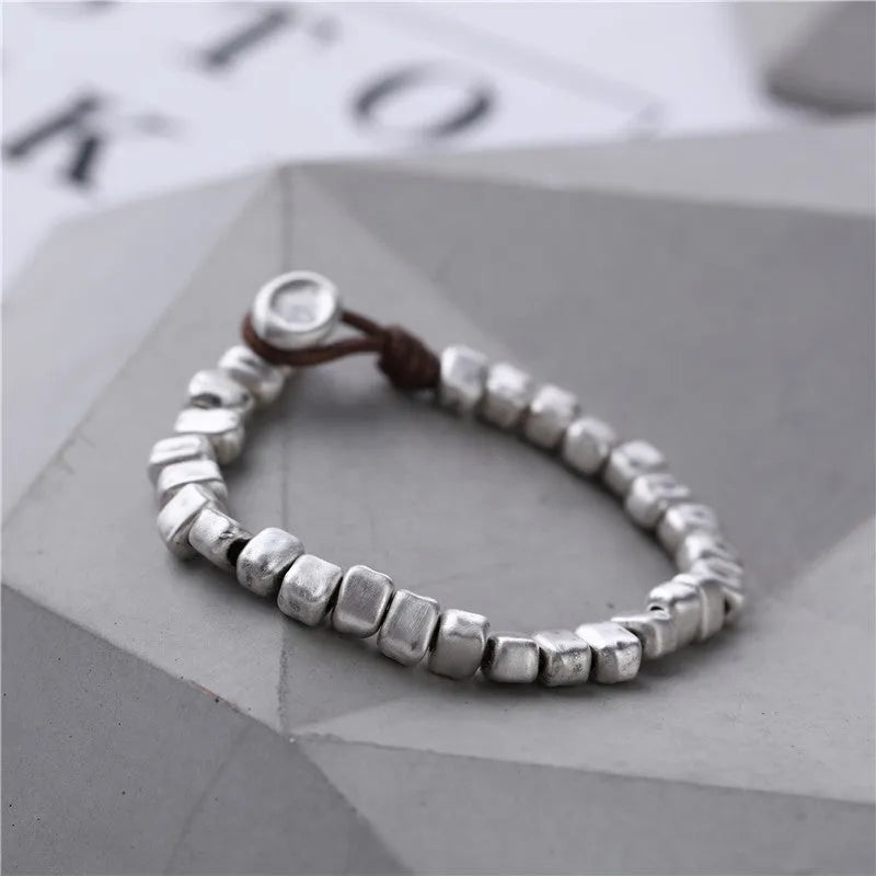 Handmade women's bracelet with irregular square design in wood and silver materials on elastic band