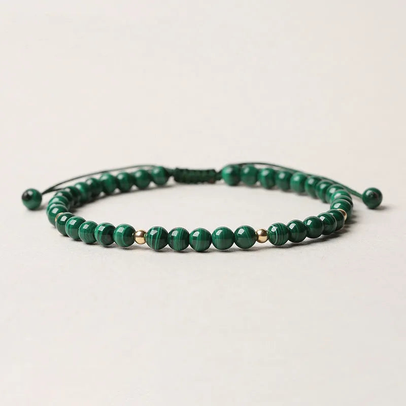 Green malachite stone bracelet with golden beads on woven strap, zodiac animal motif.