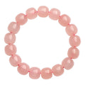 Natural pink crystal barrel bead bracelet with geometric design and polished finish