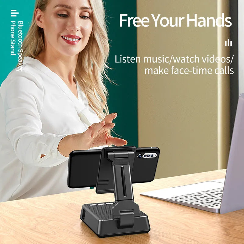 Black mobile phone smart broadcaster stand with Bluetooth speaker and HD mic on a desk