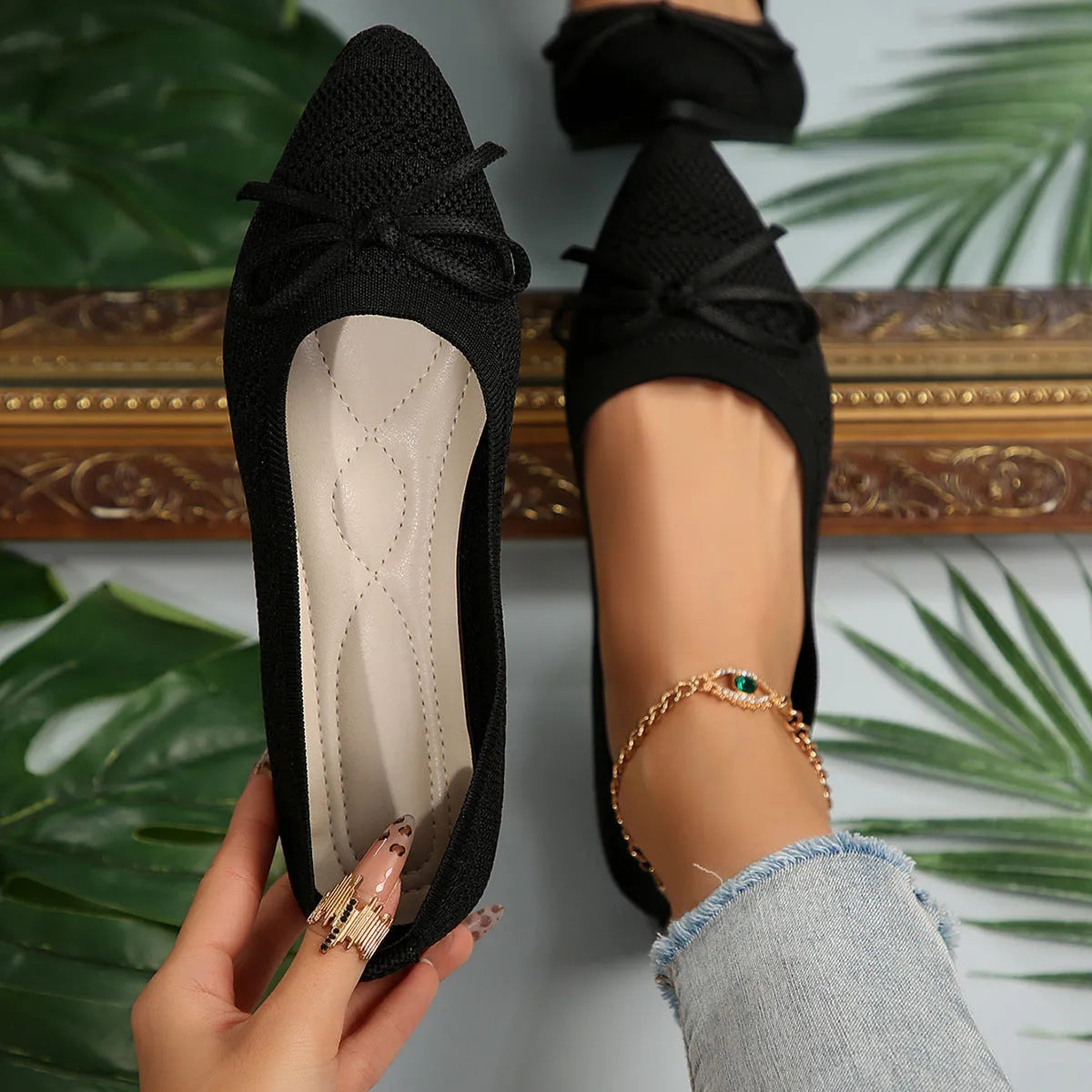 Women's blue knitted loafers with a bow and pointed toe on a flat rubber sole.