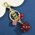 Metal hanging dice keychain pendant in cherry two-tone colour, square shape, vintage style