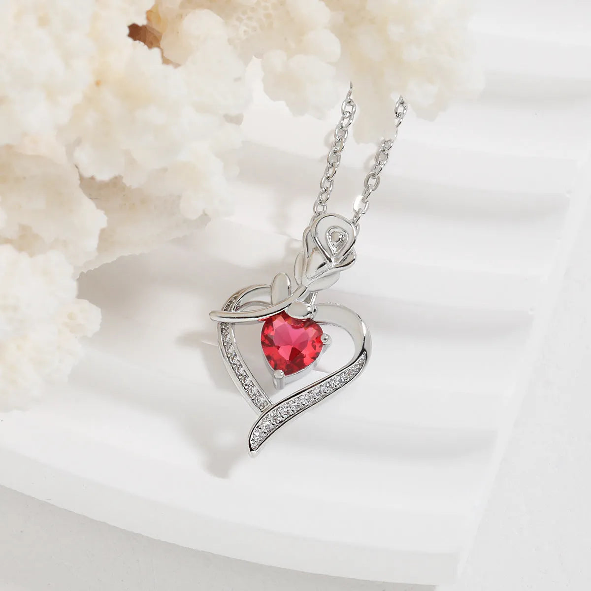 Rose heart-shaped necklace with rhinestones in copper electroplated finish, available in blue, purple, red, or white