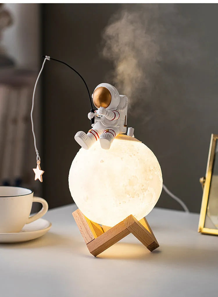 Gold astronaut resin figurine USB humidifier and night light on a wooden base