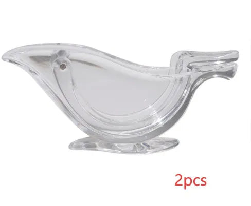 Clear acrylic bird-shaped manual lemon juicer on a kitchen counter