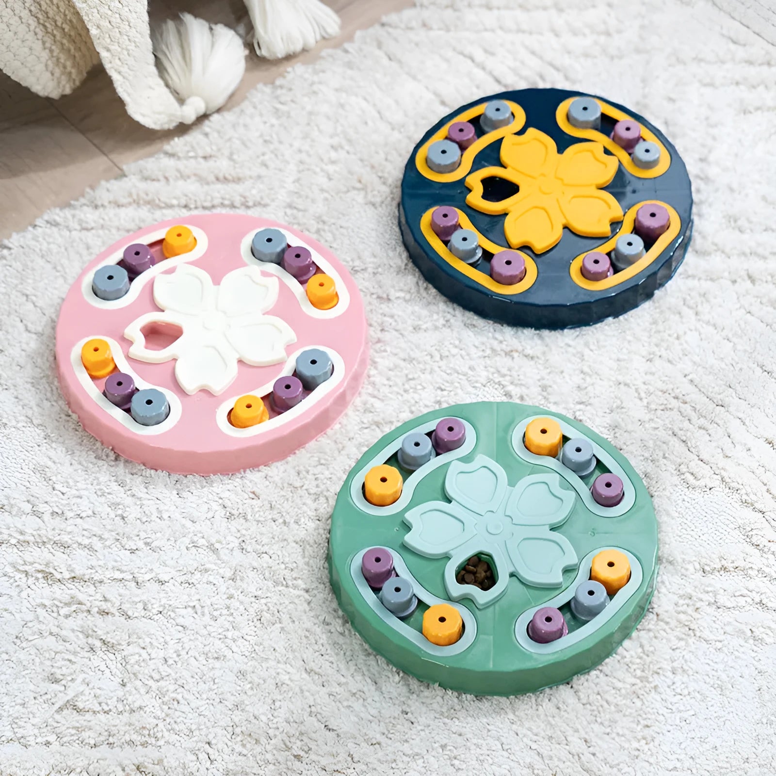 Blue interactive dog slow feeder puzzle toy with multiple food compartments on textured base