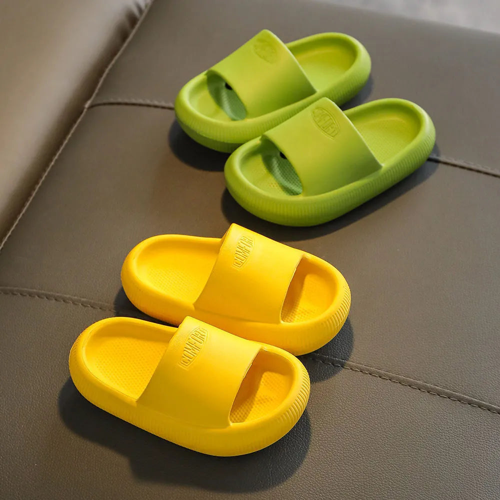 Colourful children's EVA slippers with a textured non-slip sole, shown in blue, green, orange, pink and yellow.