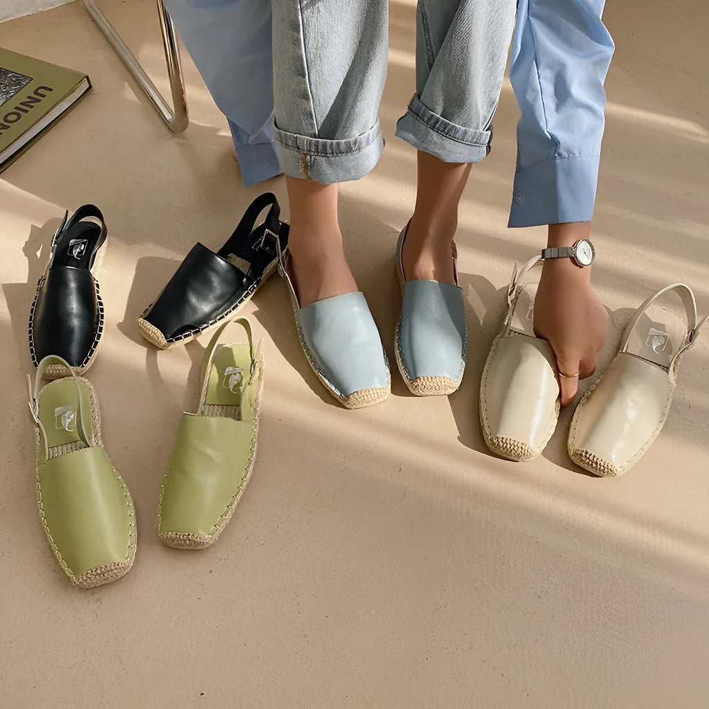 Women's retro-style canvas fisherman flat sandals in beige with animal pattern and low flat heel.