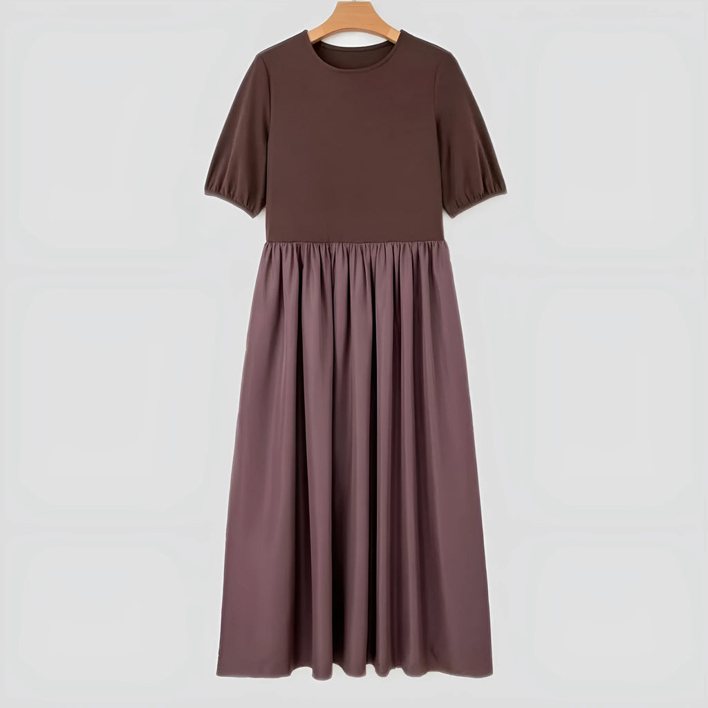 Woman wearing a coffee-coloured knitted patchwork dress with high waist and short sleeves