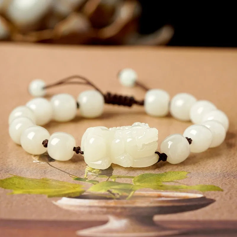 Traditional Chinese Hetian jade bracelet with black and red braided ropes and jade beads on elastic cord