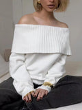 Grey off-the-shoulder strapless women's sweater with a 3D textured pattern.