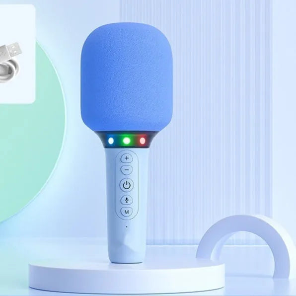 Pink Bluetooth children's handheld karaoke microphone with built-in speaker on white background