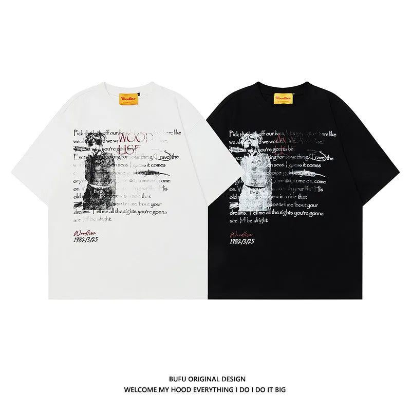 Man wearing a black loose-fit cotton T-shirt with a white printed letter pattern and raglan short sleeves.