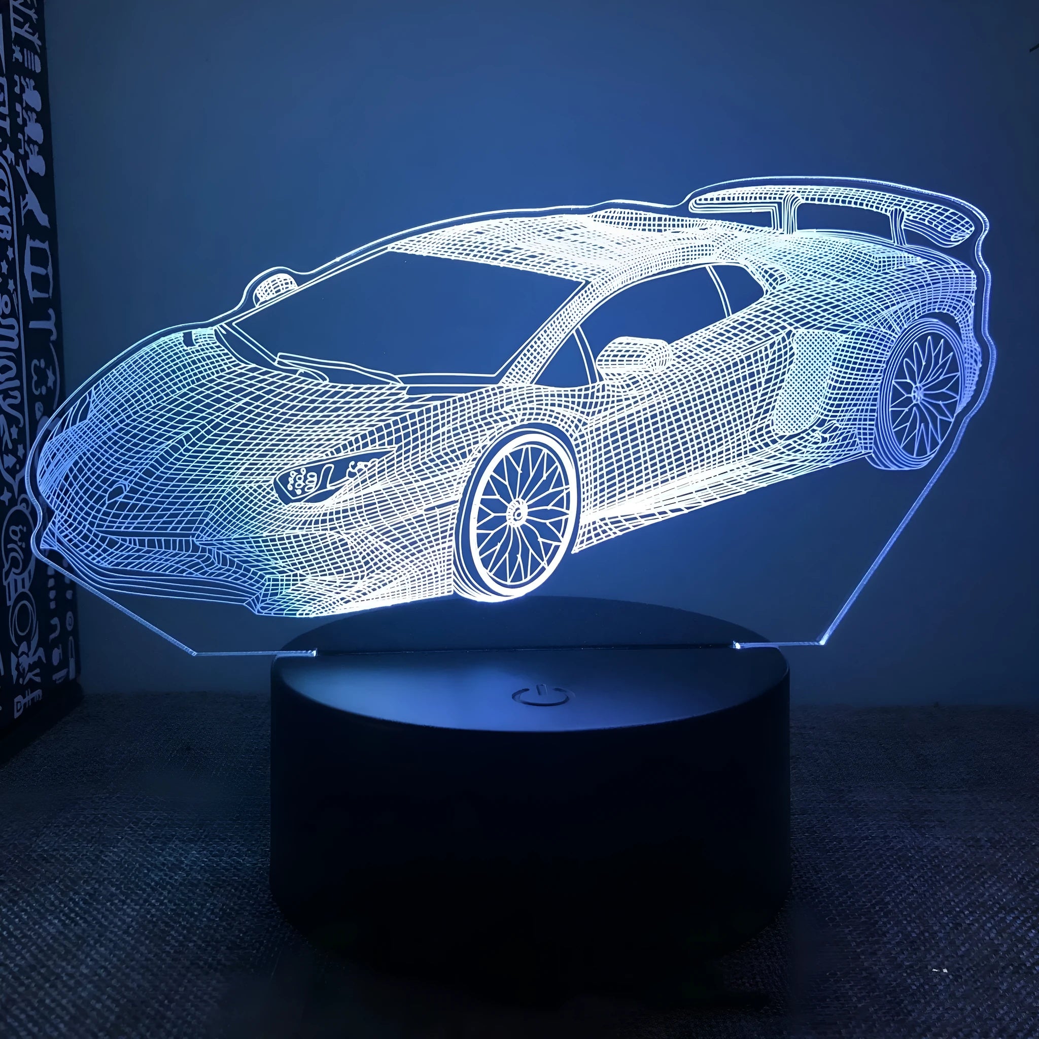 Black Sports Car shaped USB touch bedside lamp with remote control on a table.