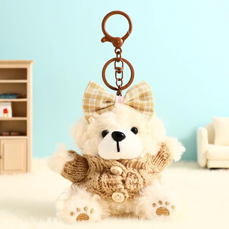 Plush biscuit bear keychain pendant with a red bow on a metal keyring