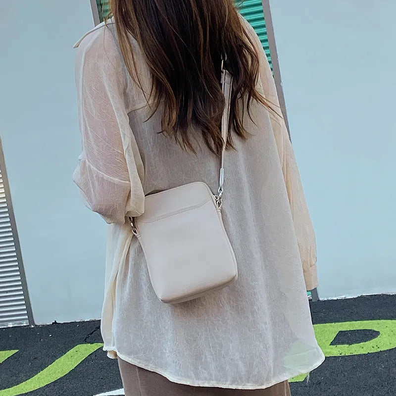 Solid colour mobile phone crossbody bag for women in black, beige, khaki, or green.