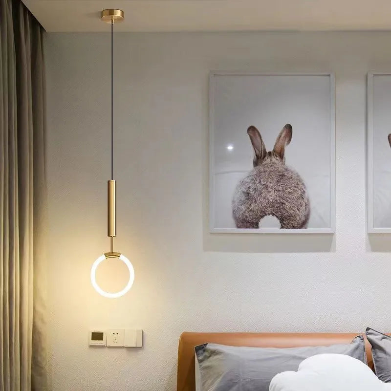 Nordic minimalist U-shaped bedside chandelier with a white shade on a pendant cord.