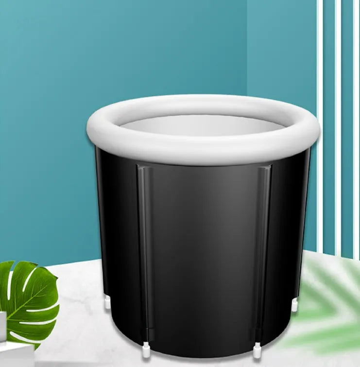 Black inflatable portable ice bath tub with weather lid, shown outdoors.