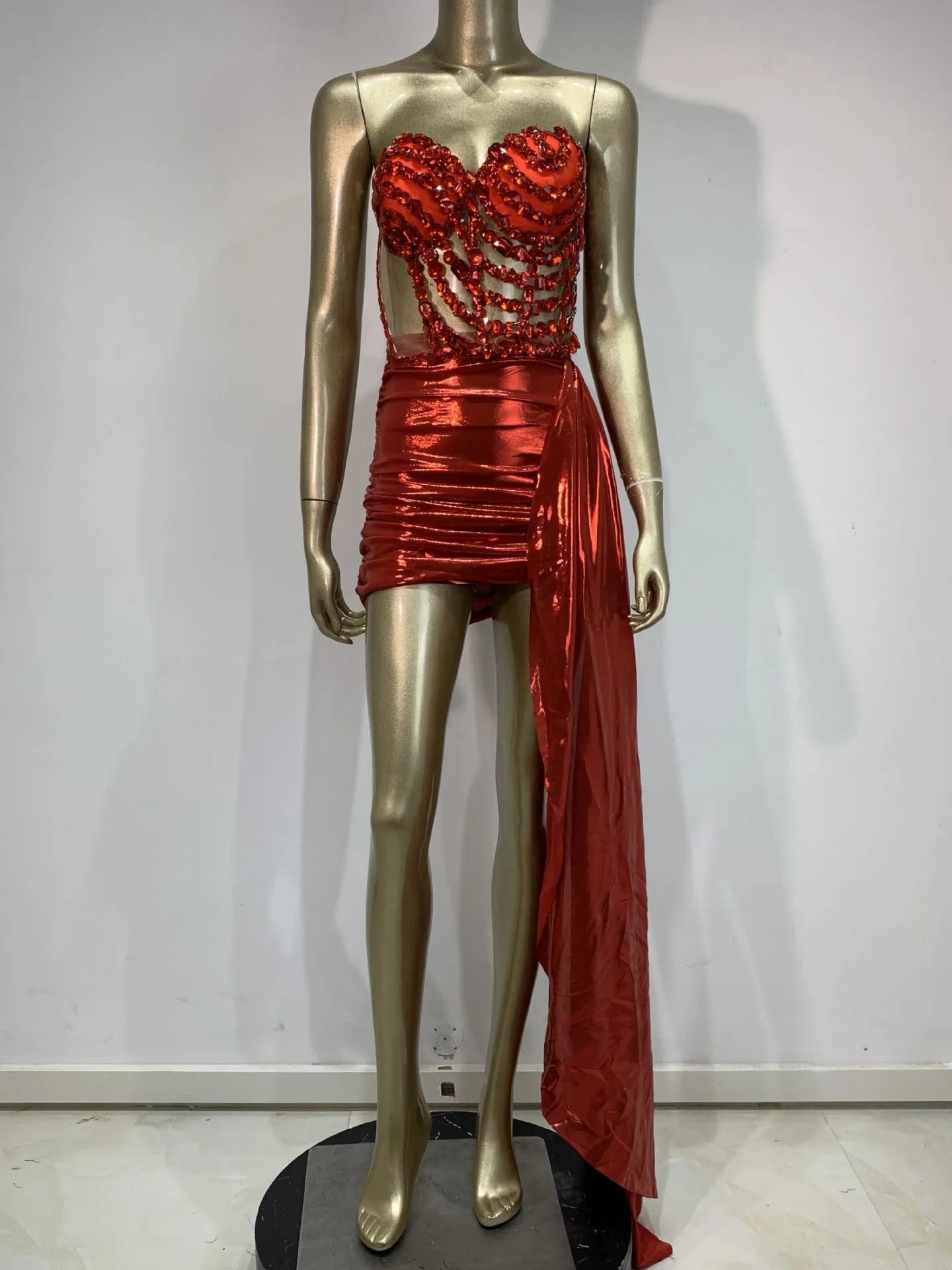 Red female skirt suit with hollow mesh see-through panels, a stage and party costume made from spandex.